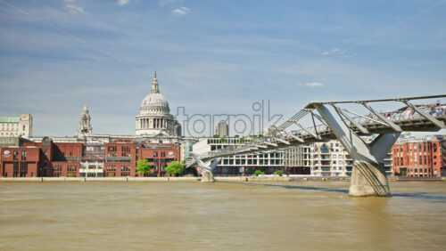 London, England – May 14, 2025: Timelapse of London’s iconic skyline featuring St. Paul’s Cathedral with a tour boat sailing along the River Thames on a sunny day - Starpik Stock