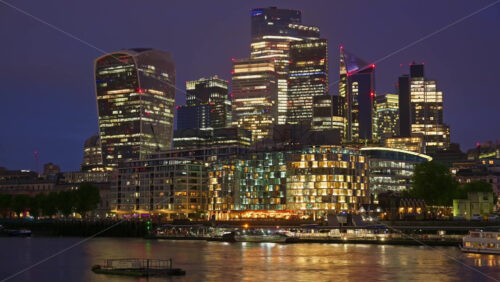 London, England – May 15, 2025: Cityscape view showing the Thames River, modern skyscrapers, including the Walkie Talkie building, and the Tower of London - Starpik Stock