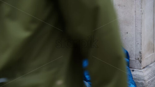 London, England – May 15, 2025: Close-up of a homeless man sitting on the floor of a station - Starpik Stock