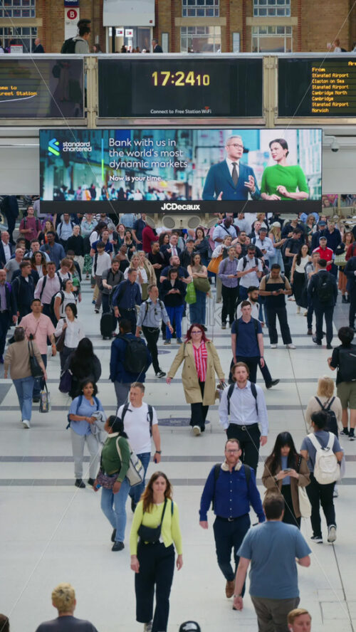 London, England – May 15, 2025: Interior of Liverpool Street busy train station filled with commuters. Vertical - Starpik Stock