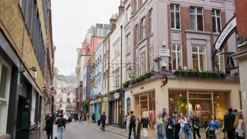 London, England – May 15, 2025: People walking on Carnaby Street with many store signs - Starpik Stock