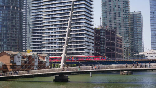 London, England – May 16, 2025: A Docklands Light Railway moving through Canary Wharf - Starpik Stock