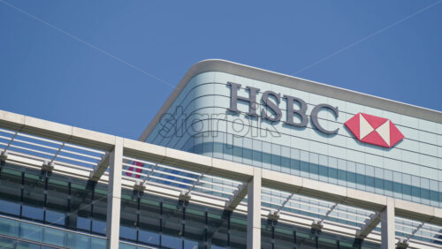 London, England – May 16, 2025: Low angle view of the HSBC headquarters building in Canary Wharf - Starpik Stock