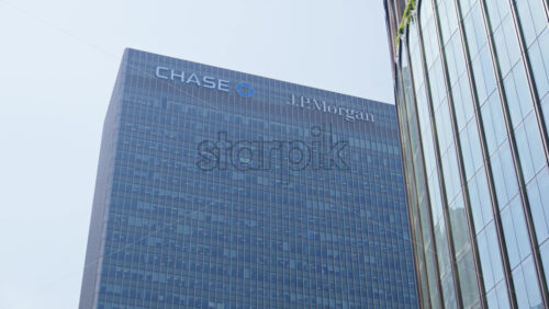 London, England – May 16, 2025: The towering Chase and JPMorgan corporate headquarters building with reflective glass windows. Canary Wharf - Starpik Stock