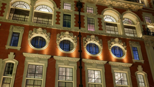 Low-angle view of a grand historical building in London, England with cloudy skies in the background in the evening - Starpik Stock