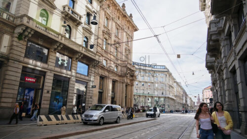 Milan, Italy – March 20, 2025: People and cars moving on the streets of the city in daylight - Starpik Stock