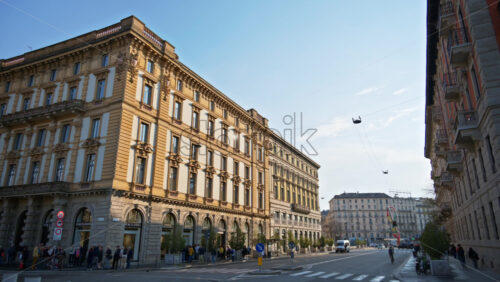 Milan, Italy – March 20, 2025: People and cars moving on the streets of the city in daylight - Starpik Stock