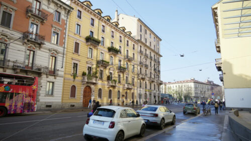 Milan, Italy – March 20, 2025: People and cars moving on the streets of the city in daylight - Starpik Stock