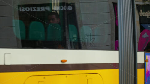 Milan, Italy – March 20, 2025: People and public transportation moving on the streets of the city in daylight - Starpik Stock