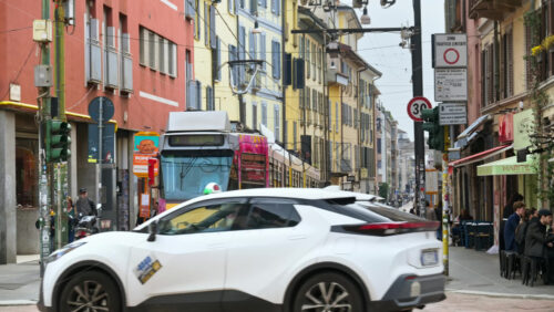Milan, Italy – March 20, 2025: People and public transportation moving on the streets of the city in daylight - Starpik Stock