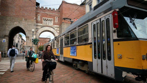 Milan, Italy – March 20, 2025: People and public transportation moving on the streets of the city in daylight - Starpik Stock