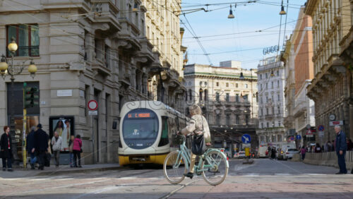 Milan, Italy – March 20, 2025: People, cars and public transportation moving on the streets of the city in daylight - Starpik Stock