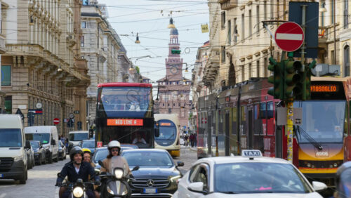 Milan, Italy – March 20, 2025: People, cars and public transportation moving on the streets of the city in daylight - Starpik Stock