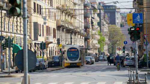 Milan, Italy – March 20, 2025: People, cars and public transportation moving on the streets of the city in daylight - Starpik Stock