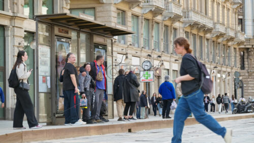 Milan, Italy – March 20, 2025: People waiting for the tram at the station - Starpik Stock