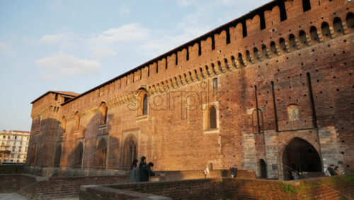Milan, Italy – March 20, 2025: People walking around at the Sforzesco Castle in daylight - Starpik Stock