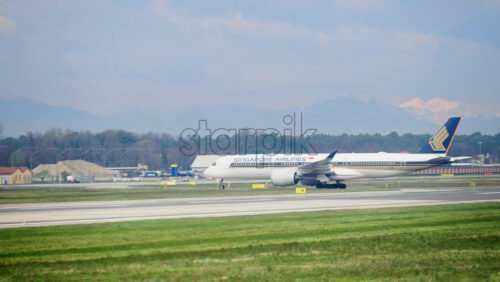 Milan, Italy – March 20, 2025: Singapore Airlines plane moving through the airport - Starpik Stock