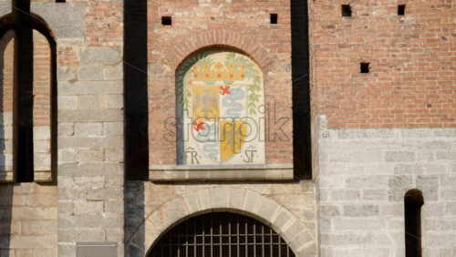 Milan, Italy – March 20, 2025: The seal above the entrance of the Sforzesco Castle in daylight - Starpik Stock