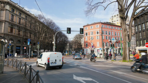 Milan, Italy – March 21, 2025: Cars and public transportation moving on the streets of the city in daylight - Starpik Stock