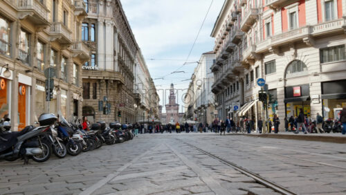 Milan, Italy – March 21, 2025: Distant view of the Filarete Tower between buildings in Milan, Italy in daylight - Starpik Stock