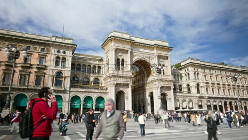 Milan, Italy – March 21, 2025: Multiple people walking through the Duomo Square in daylight - Starpik Stock