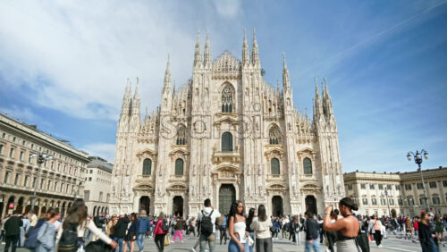 Milan, Italy – March 21, 2025: Multiple people walking through the Duomo Square in daylight - Starpik Stock