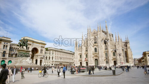 Milan, Italy – March 21, 2025: Multiple people walking through the Duomo Square in daylight - Starpik Stock