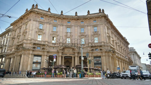 Milan, Italy – March 21, 2025: People and cars moving in front of the Palazzo Broggi - Starpik Stock