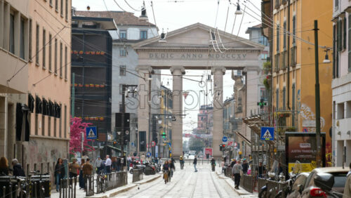 Milan, Italy – March 21, 2025: People and cras moving near the Medieval Ticinese Gate in daylight - Starpik Stock