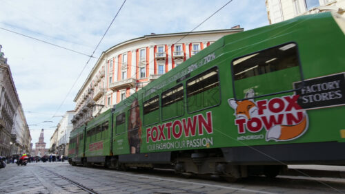 Milan, Italy – March 21, 2025: People and public transportation moving on the streets of the city in daylight - Starpik Stock