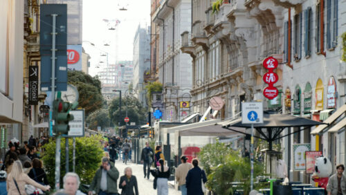 Milan, Italy – March 21, 2025: People walking on the streets of the city in daylight - Starpik Stock