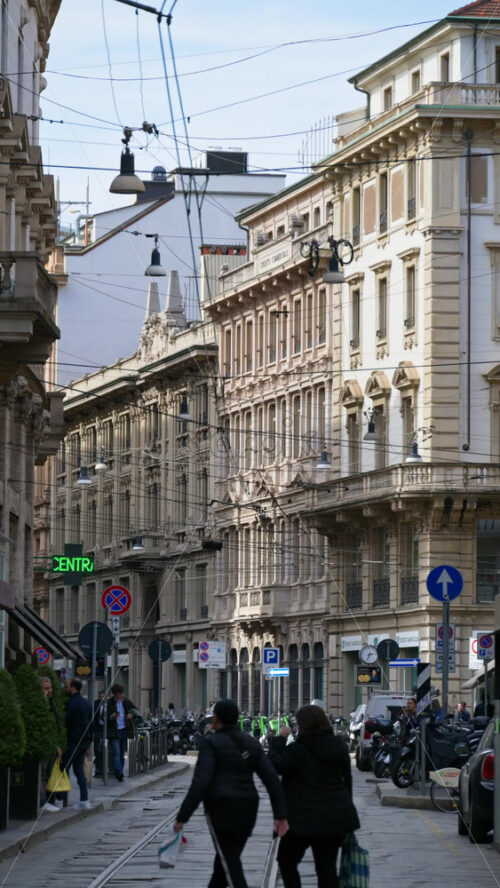 Milan, Italy – March 21, 2025: People walking on the streets of the city in daylight. Vertical - Starpik Stock