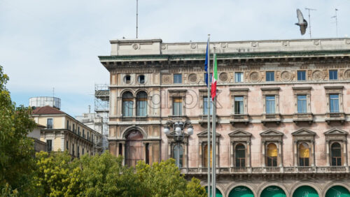 Milan, Italy – March 21, 2025: The Vittorio Emanuele II Gallery view from the outside over a blue sky - Starpik Stock