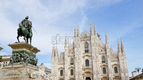 Milan, Italy – March 21, 2025: The Vittorio Emanuele II Statue in the Duomo Square with the gallery and the cathedral on the background in daylight - Starpik Stock