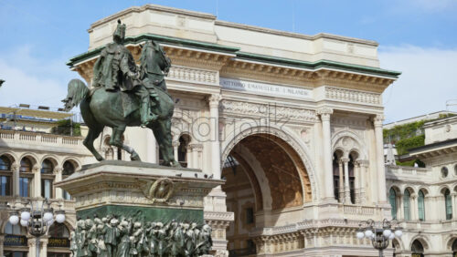 Milan, Italy – March 21, 2025: The Vittorio Emanuele II Statue in the Duomo Square with the gallery on the background in daylight - Starpik Stock