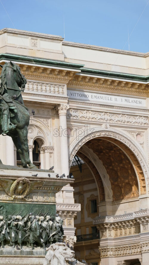 Milan, Italy – March 21, 2025: The Vittorio Emanuele II Statue in the Duomo Square with the gallery on the background in daylight. Vertical - Starpik Stock