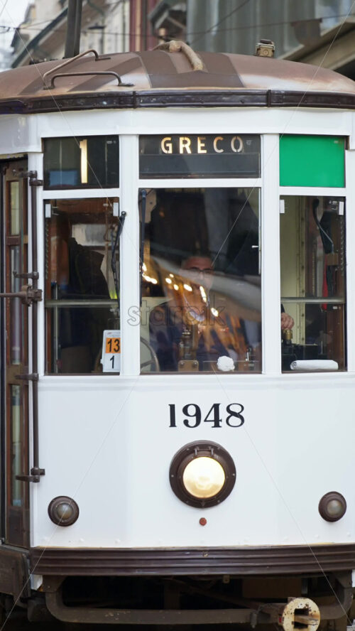 Milan, Italy – March 21, 2025: Tram moving on the streets of the city in daylight. Vertical - Starpik Stock