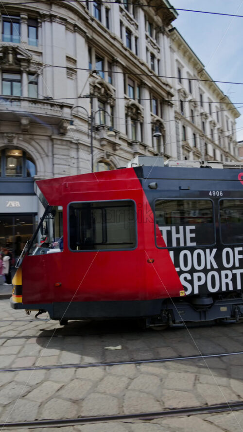 Milan, Italy – March 21, 2025: Tram passing by on the street of the city in daylight. Vertical - Starpik Stock