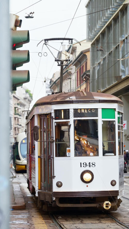 Milan, Italy – March 21, 2025: Tram waiting on the streets of the city in daylight. Vertical - Starpik Stock