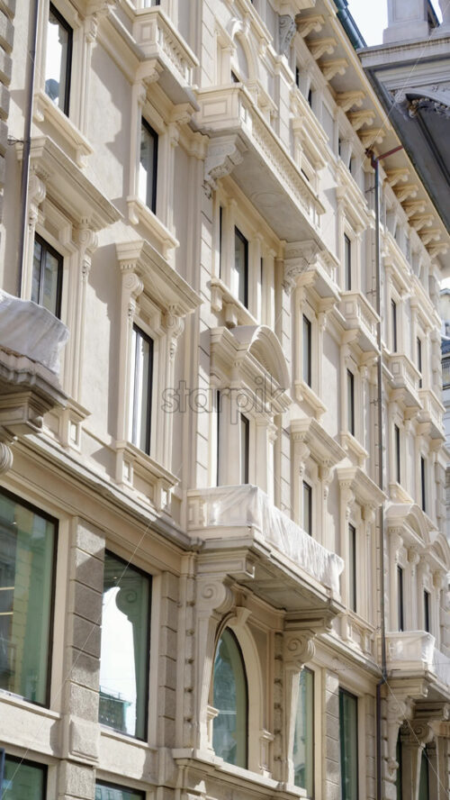 Milan, Italy – March 21, 2025: View of a white building in the city in daylight. Vertical - Starpik Stock