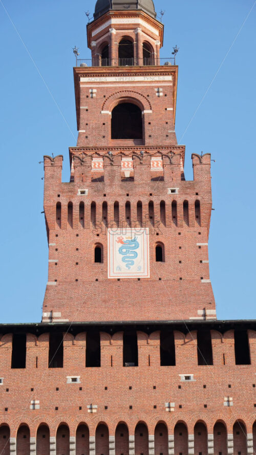 Milan, Italy – March 21, 2025: View of the Filarete Tower on the blue sky background. Vertical - Starpik Stock