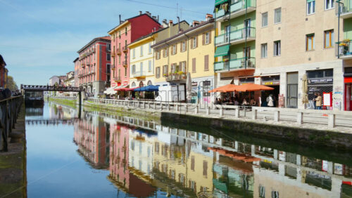 Milan, Italy – March 21, 2025: View of the colourful buildings surrounding the Naviglio Canal in daylight - Starpik Stock
