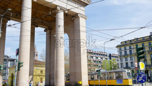 Milan, Italy – March 21, 2025: Yellow tram moving on the streets of the city in daylight - Starpik Stock