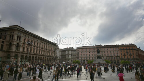 Milan, Italy – March 22, 2025: Multiple people walking through the Duomo Square in daylight - Starpik Stock