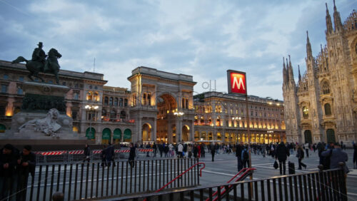 Milan, Italy – March 22, 2025: Multiple people walking through the Duomo Square in the evening - Starpik Stock