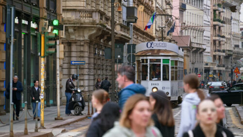 Milan, Italy – March 22, 2025: People, cars and public transportation moving on the streets of the city in daylight - Starpik Stock