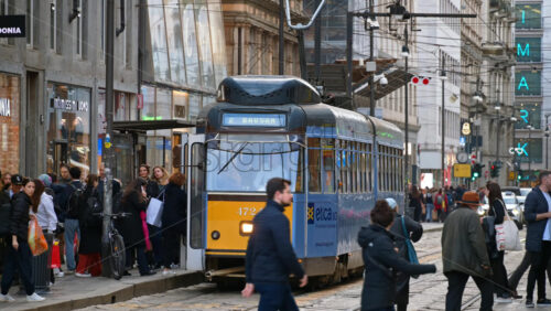 Milan, Italy – March 22, 2025: People, cars and public transportation moving on the streets of the city in daylight - Starpik Stock