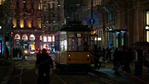 Milan, Italy – March 22, 2025: People getting in and out of the tram at night - Starpik Stock