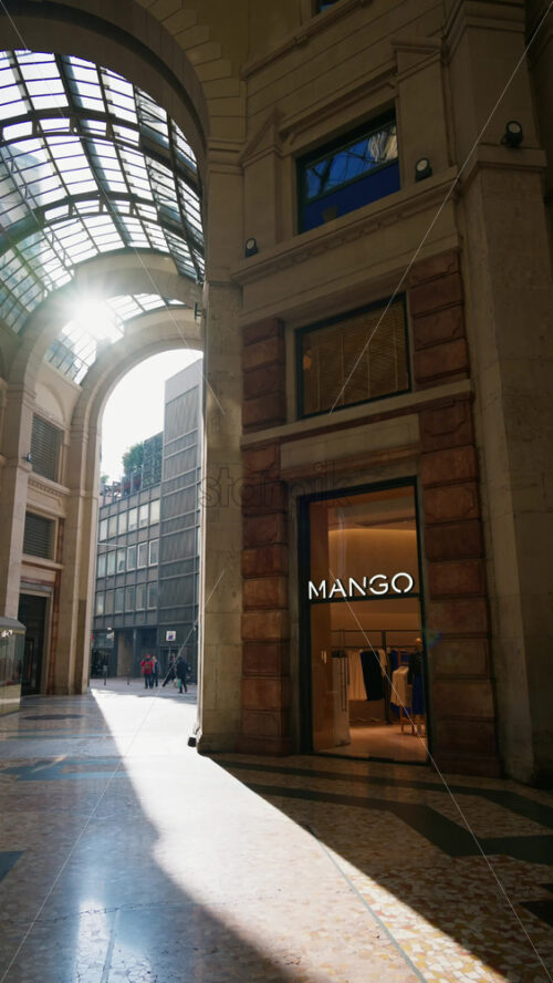 Milan, Italy – March 22, 2025: People walking near stores in the Corso Gallery in daylight. Vertical - Starpik Stock