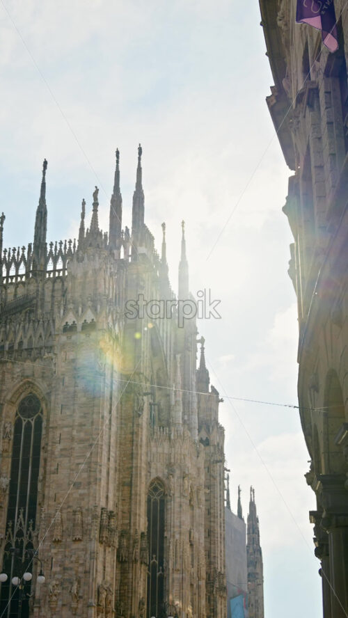 Milan, Italy – March 22, 2025: Side view of the Duomo Cathedral with sunlight - Starpik Stock